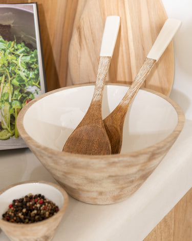 Mango wood salad bowl with white glazed interior in lifestyle photo