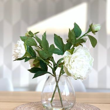 Whiteopen peony arrangement with faux water and vase